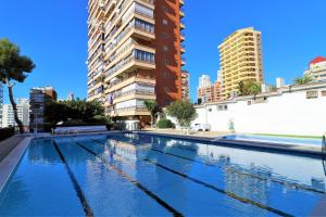 a swimming pool in a city with tall buildings at Piscis 12-2 in Benidorm