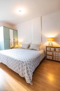 1 dormitorio con 1 cama con colcha blanca en Le Mazagran, en Saint-Paul-Trois-Châteaux