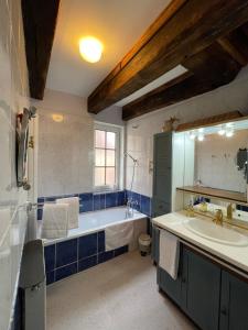 a large bathroom with a tub and a sink at Le Colombier de Cyrano et Roxane in Bergerac +50 photos