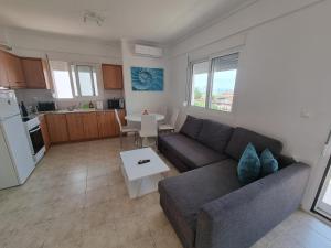 a living room with a couch and a table at Lucas2 Lux Flogita apartment in Flogita