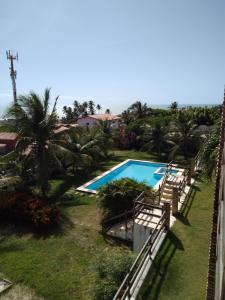 a view of the pool from the balcony of a resort at Zago Apartamento Temporada Vista Mar in Aquiraz