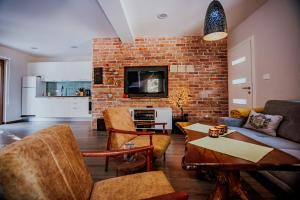 a living room with a brick wall at Luna in Blidinje