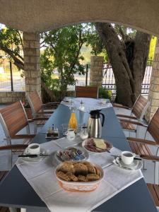 a blue table with a plate of food on it at Bed&Breakfast Drage in Drage