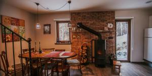 a dining room with a table and a fireplace at Luna in Blidinje