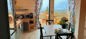 Górskie domki w Karkonoszach z widokiem في بودوغوجن: طاولة وكراسي على شرفة مطلة على المحيط