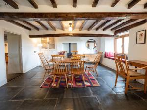 a dining room with a table and chairs at Wayside Cottage 1637 in Millom