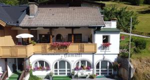 a house with a balcony and flowers on it at Haus Hamatli in Sankt Anton am Arlberg