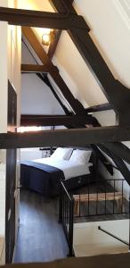 a attic room with a bed in a loft at De Biecorff in Middelburg