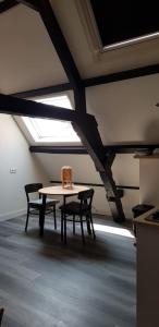 a table and two chairs in a room with a ceiling at De Biecorff in Middelburg