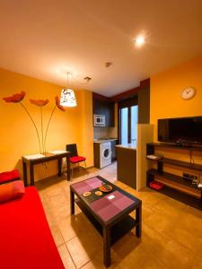 TV a/nebo společenská místnost v ubytování Apartamentos Turisticos Graus