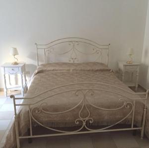 a bed in a bedroom with two end tables at Villa Caterina in Sapri