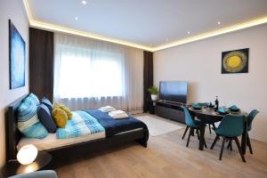 a bedroom with a bed and a dining room at NETTA APARTMAN in Eger