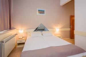 Postel nebo postele na pokoji v ubytování Hotel MB