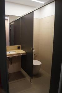 a bathroom with a toilet and a sink and a mirror at Alberg Los Josepets in Les Cases d'Alcanar