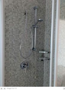 a shower with a shower head in a bathroom at Villa Rosa in Lignano Sabbiadoro