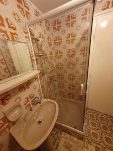a bathroom with a sink and a shower at Wolf Vendégház in Balatonkeresztúr +25 photos
