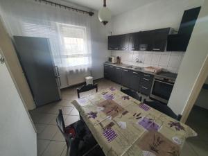 a kitchen with a table with a table cloth on it at Wolf Vendégház in Balatonkeresztúr