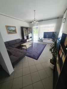 uma sala de estar com um sofá e uma mesa em Wolf Vendégház em Balatonkeresztúr