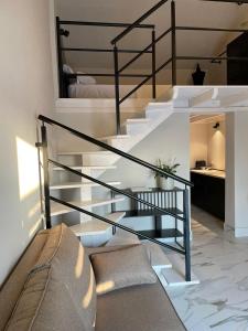 a black spiral staircase in a room with a bed at Hacienda Soto-Hego Haizea in Chiclana de la Frontera