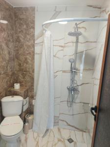 a bathroom with a shower with a toilet at Villa Valentines in Kiten +78 photos