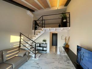 a living room with a staircase and a couch at Hacienda Soto-Hego Haizea in Chiclana de la Frontera