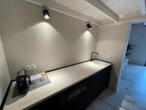 a room with a counter with a phone on the wall at Hacienda Soto-Hego Haizea in Chiclana de la Frontera