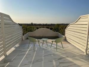 a patio with two chairs and a table on a roof at Hacienda Soto-Hego Haizea in Chiclana de la Frontera