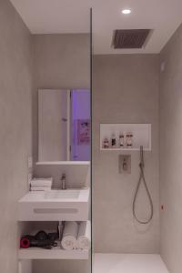 a bathroom with a sink, toilet and mirror at ODSweet Duomo Milano Hotel in Milan