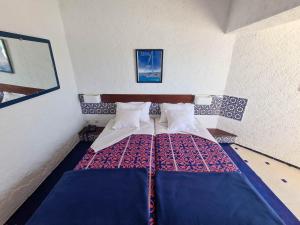 Postelja oz. postelje v sobi nastanitve UMH Tarik Hotel