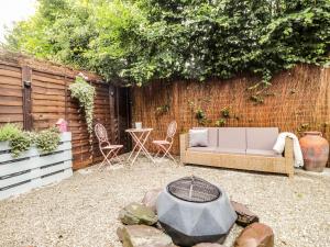 a backyard with a couch and a fire pit at Ditsys Den in Tonbridge