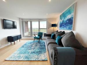 a living room with a couch and a table at Ocean Gate 24 in Newquay