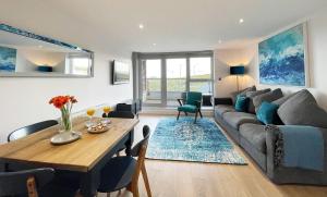a living room with a couch and a table at Ocean Gate 24 in Newquay