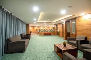 a lobby with couches and a table in a room at Hotel One Gulberg, Lahore in Lahore