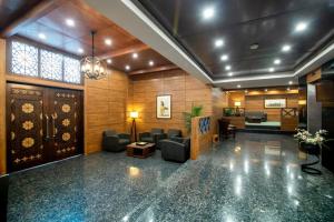 a lobby with a waiting room with chairs and a door at Hotel One Gulberg, Lahore in Lahore