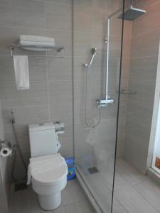 a bathroom with a toilet and a glass shower at French Hotel in Ipoh