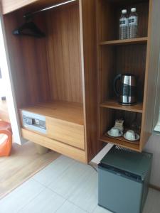 a cupboard with a microwave and a coffee maker at French Hotel in Ipoh