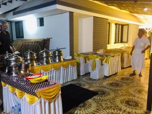 a group of tables with pots on them in a room at Stylehomes The Farm House Inn (Heritage Resort) in Lokamaleswaram