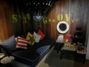 a room with a couch with pillows and a mirror at French Hotel in Ipoh