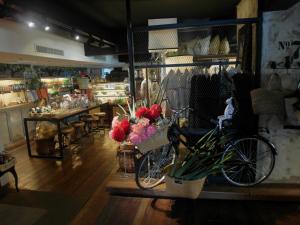 a store with a bike and flowers in a room at French Hotel in Ipoh