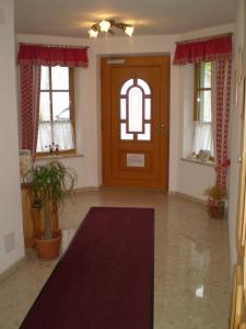 a living room with a brown door and windows at Landhaus Gruber Sommer in Sankt Johann im Pongau