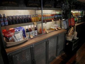 a bar with bottles of beer and drinks on display at French Hotel in Ipoh