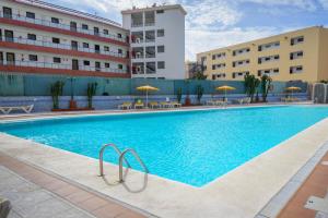 a large swimming pool in front of a building at Apartamentos Las Arenas in Playa del Ingles