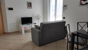 a living room with a chair and a television at Casa Torboli in Arco