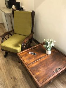a chair and a wooden table with a table sidx sidx sidx at The Guesthouse Klerksdorp in Klerksdorp