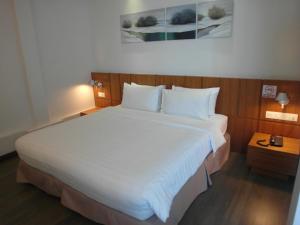 a bedroom with a large white bed in a room at French Hotel in Ipoh