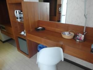 a bathroom with a white toilet and a mirror at French Hotel in Ipoh