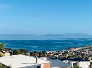 a view of a city and the ocean at On the GBay Villa in Gordonʼs Bay