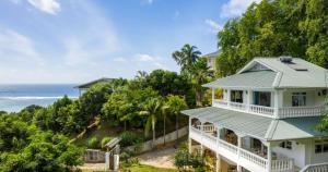 an image of a house with the ocean in the background at Villa Karibu in Au Cap