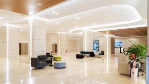 a lobby with chairs and tables in a building at The November Stay In landmark in Incheon