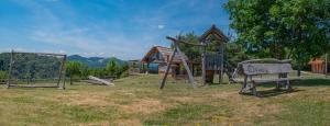 un parque con parque infantil con columpios en Holiday Home Ernest Železni with hot tub, en Ivančna Gorica